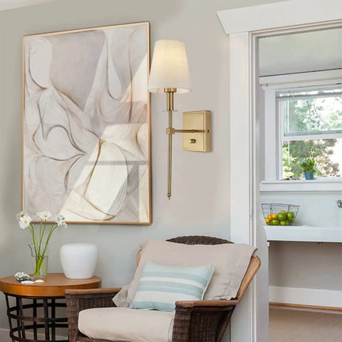 Living room with Gold Linen Wall Sconce Dimmable On Off Dimmer Modern Bathroom Vanity Light beside abstract art and wicker chair.