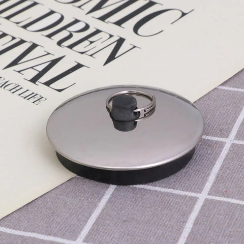 2pcs Rubber Bathtub Drain Stopper Black for Bathroom and Laundry with metal ring and flat cover on a textured surface.