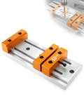 Low Profile Mini Vise Clamp For CNC Router Machines, Beefy Aluminum, Precision CNC Machined For Flat Surfaces, Ultra Slim Design Keeps Toolpaths Clear And Grips Solid On Milling Projects, orange aluminum clamp on CNC table
