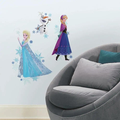 Disney Frozen Anna Elsa and Olaf Peel and Stick Giant Wall Decals Set on kid's room wall with chair, colorful figures, made in USA.