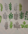 Eight Piece Leaf Metal Die Cuts Set For Scrapbooking And Card Making, showing diverse floral designs in green and silver, 9.7 by 10.9 cm.