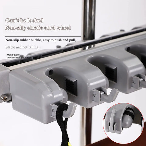 Close-up of non-slip rubber holders on Sturdy Stainless Floor Standing Broom And Mop Rack On Wheels Movable Cleaning Tool Cart.