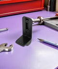Heavy Duty Speaker Casters Pair Of Non Swivel Wheels With L Bracket Side Mount and Shock Resisting Rubber Treads on purple table.
