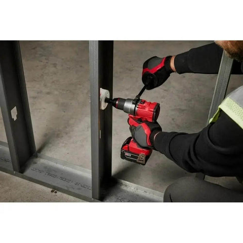 User operating Pro Level 18V Cordless Brushless 1/2 Inch Drill And Driver Bare Tool on metal framing, showcasing its durability.