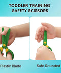 Child using 3 Pack Toddler Safety Scissors Kit with child-safe green scissors with plastic blade and rounded tips.