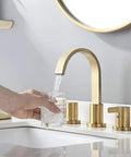 Two Handles 8 Inch Widespread Bathroom Faucet In Brushed Gold Finish With Valve And Metal Pop Up Drain Three Hole Mount Eight Inch Center Spread Sleek Modern Diy Bathroom Upgrade displayed with flowing water