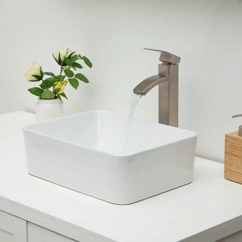 Rectangular White Vessel Sink 16 By 12 Inch Modern Above Counter Porcelain Ceramic Vanity Basin For Home Bathroom Remodel Easy To Clean Non Porous Glaze Durable Sleek Contemporary Countertop Sink with water flowing from faucet on countertop