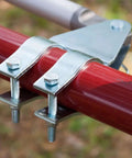 Universal Tube Gate Bracket Kit For Automatic Gate Opener Systems in stainless steel on red tube, side view