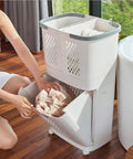 Person using Removable Laundry Basket With Sturdy Storage Rack On Wheels White Household Organizer For Laundry And Home Storage Bottom Opening For Quick Access Durable PP Material Privacy Safe Design Easy Grab And Go