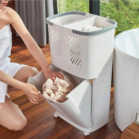 Person using Removable Laundry Basket With Sturdy Storage Rack On Wheels White Household Organizer For Laundry And Home Storage Bottom Opening For Quick Access Durable PP Material Privacy Safe Design Easy Grab And Go