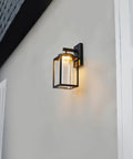 Capulet Amber Glass Center Column Outdoor Indoor Wall Sconce With LED Black Finish on building wall