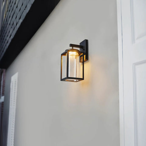 Capulet Amber Glass Center Column Outdoor Indoor Wall Sconce With LED Black Finish on building wall