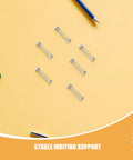 Top Notch 100 Piece Stainless Steel Compression Springs Kit For DIY Fixes And Repair Projects Featuring Snappy Pen Return Technology That Guarantees Smooth Writing Flow Every Single Time With Rust Resistant Metal Mini Springs You Can Count On, stainless steel pen springs on yellow background