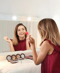Woman using Hollywood Style LED Vanity Mirror Lights With 14 Dimmable Bulbs USB Powered Stick On Lights for makeup table