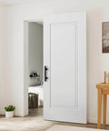 Concealed Barn Door Kit 36x84 with Soft Close Hardware and Matte Black Pulls, white primed solid core installed in room.