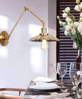Badass Heavy Duty Swing Arm Wall Lamp, Adjustable Bronze Sconce, vintage fixture illuminating dining table with elegant decor.