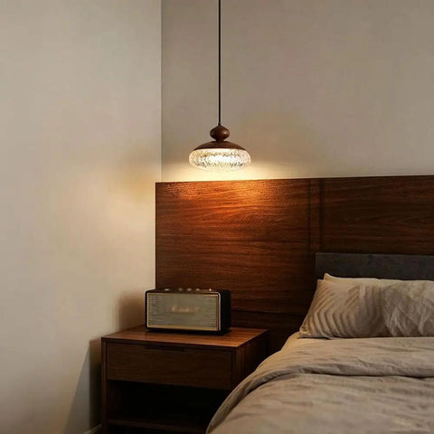 Wood Grain Pendant Light, 3 Color LED Resin Hanging Fixture for Bedroom illuminating a cozy bedside with modern decor.