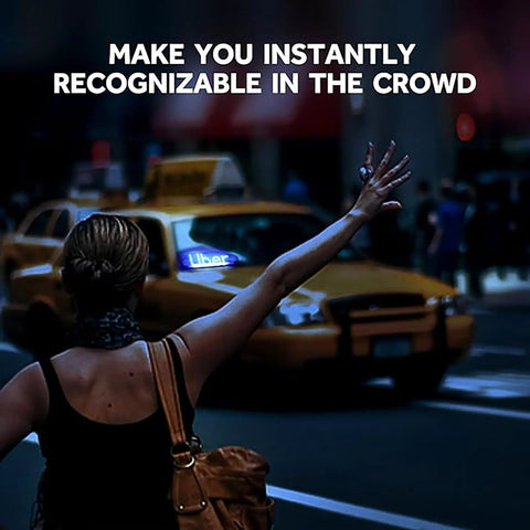 Person hailing a taxi at night with bright blue LED car light sign visible in background, enhancing high visibility in the crowd