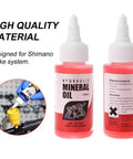 Two bottles of hydraulic mineral oil for Shimano brake systems with high quality label and usage instructions.