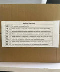 Safety warning label on cardboard box in multiple languages highlighting fire safety precautions.