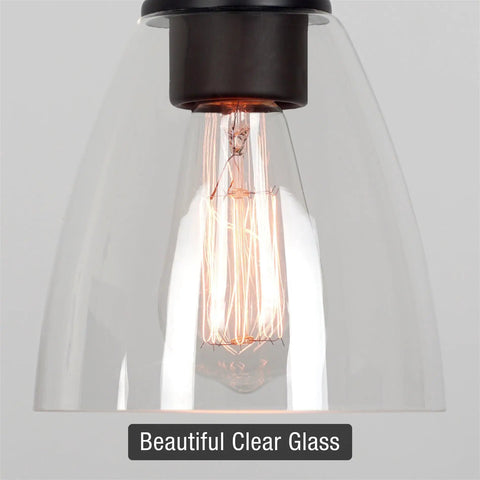 Close-up of clear glass lamp shade from 3-Pack Modern Cone Shape 6x5.75 Inch 1-5/8 Inch Fitter with Edison bulb