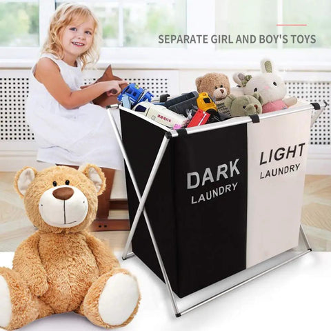 Girl playing near two section laundry basket hamper foldable waterproof cloth organizer with aluminum X frame and toys.
