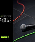 Dynamic Vocal Microphone With On Off Switch Cardioid Pattern Built In Pop Filter For Live Shows And Studio Recording Perfect For Singers Speakers And Stage Use Black, shown on stage with colorful cables.