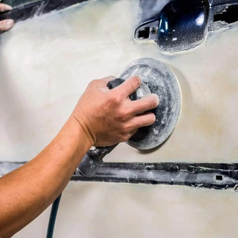 Heavy Duty 6 Inch Hook and Loop Sanding Discs With 15 Holes For Quick Dust Collection used on a surface for sanding.
