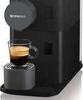 Zero Stress Single Serve Coffee Brewer With Built In Milk Frother For Rich Latte Perfection, sleek black with espresso cup.