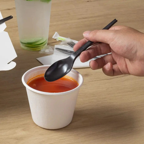 Six Point Five Inch Wrapped Compostable Spoons For Hot And Cold Food 250 Individually Wrapped Plant Based Black CPLA Disposable Utensils BPI Certified Eco Friendly Cutlery For Restaurants And Events black CPLA spoon over soup cup
