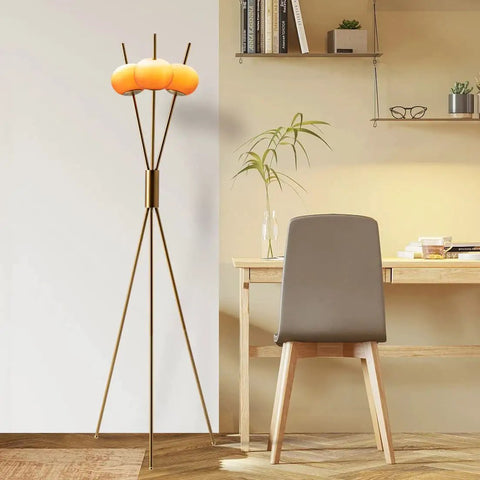 Three Light Floor Lamp With Gold Plated Tripod Stand Modern Amber Glass Lampshade 28W Flexible Cozy Glow Light For Living Room Bedroom Hallway And Office With Bulb in a cozy workspace.