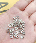 Hand holding 1200pcs Silver Flower Shape Septal Beads, Daisy Spacers CCB Spacer Beads For Bracelet Necklace Earring Jewelry Making