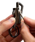 Hand holding Permanent Match Bottle Opener Keychain, Reusable Survival Fire Starter Striker Lighter in use.