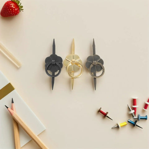 Vintage Style Retro Cabinet Drawer Pull Handles Set 15 Pieces, featuring three handles in black, gold, and silver on a beige surface.