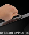 Close-up of hand peeling Slick Self Adhering Stainless Steel Black Metalized Wall Trim Molding With Mirror Like Finish.