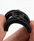 Hand holding a black 2 Pack Bike Bottom Bracket Cable Guide Set With Anti Friction Cable Holder for quiet, smooth gear shifting.
