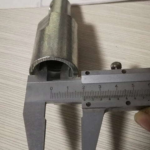 Measuring the width of an Electric SDS Shank Converter Adapter For Drill Bits And Power Tools with calipers.
