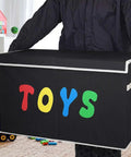 Person holding Extra Large Collapsible Toy Box Chest With Lids For Kids Storage in playroom.