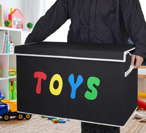 Person holding Extra Large Collapsible Toy Box Chest With Lids For Kids Storage in playroom.