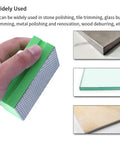 Hand holding foam-backed green polishing pad from Four Piece Diamond Hand Polishing Pads Set For Ceramic Tile And Glass, Handheld Sanding Blocks.