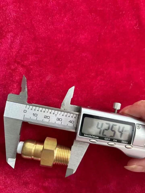 Close-up of brass thermal relief valve with 3/8 in NPT threads for a pressure washer pump; caliper shows about 42.5 mm.