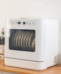 Skip the Sink Fully Automatic Desktop Dishwasher For Home Kitchen Large Capacity Auto Wash System With Triple Filter And Front Loading Design Easy Setup Plumbing Free Hands Off Cleanup Routine with dishes inside on a wooden countertop.