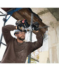 Man using Built Different Heavy Duty Cordless Rotary Hammer Drill With Brushless Motor drilling into masonry on scaffolding.
