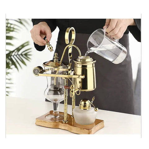 Top Shelf Siphon Coffee Maker Serving Up Smooth Brews And Chill Cold Steeps With Heavy Duty Glass And Classic Retro Styling Made For Any Casual Home Setup Without Mess Or Hassle, with gold accents and glass components.