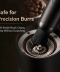 Close-up of Rechargeable Mini Coffee Grinder Vacuum Cleaner with brush attachment cleaning burrs