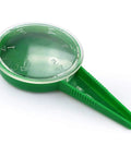 Close-up of green seed dispenser from 4 Pack Garden Hand Planter Seeder Tool Set with Adjustable Seed Dispenser for sowing seeds.