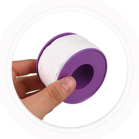PTFE Thread Seal Tape For Plumbing Waterproof Pipe Tape Quick Wrap For Plumbers Multipack For Emergency Repairs And Installations On Threaded Pipes Versatile Leak Free Sealing Easy Application And Long Lasting Performance. White PTFE tape roll in purple dispenser, held by hand