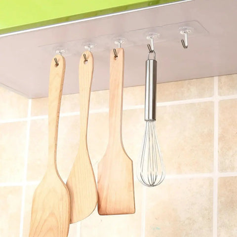 Heavy Duty Self Adhesive Hooks 50 Pack Waterproof Shower Wall Mounts No Drill Damage Free Reusable Utility Holders That Stick Like Crazy And Keep Things Tidy Without The Hassle. Kitchen utensils hanging on clear adhesive hooks.
