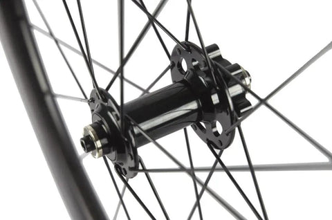 Close-up of the hub and spokes on Carbon Disc Wheelset 50C-23 Clincher Road Wheel Six Bolt Rotor 12x100 Thru Axle Built For Speed.