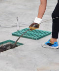 Person using Heavy Duty Sewer Drain Snake Built Like A Beast Manganese Steel Plumbing Auger for clearing outdoor drain.